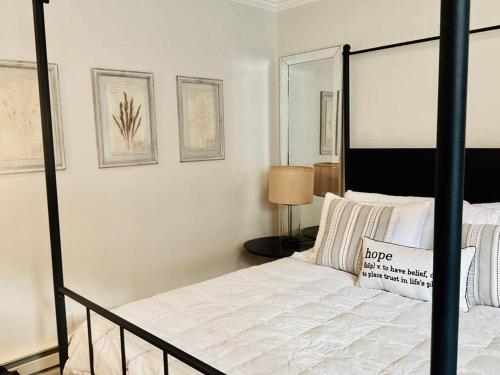 a bedroom with a white bed with a black frame at Beautiful Modern In-town Studio with Kitchenette in Telluride