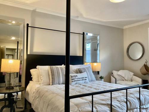 a bedroom with a bed with a black frame and a mirror at Beautiful Modern In-town Studio with Kitchenette in Telluride