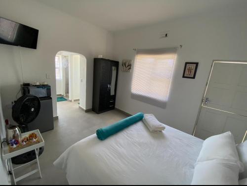a bedroom with a white bed with a blue headboard at No 1 Guest house in Cape Town