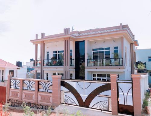 a house with a gate and a fence at White Ark Apartment in Kigali