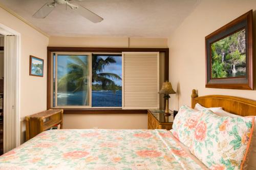 a bedroom with a bed and a window at Hana Kai Maui - #4 Nanuʻalele Oceanfront 1 BR in Hana