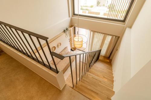 a staircase with a glass table and a window at ADORNO PRIVATE SUITES Only Adults & Kids 12 Plus in Nea Vrasna