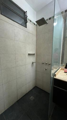 a bathroom with a shower with a glass door at Casa Antigua in San Francisco