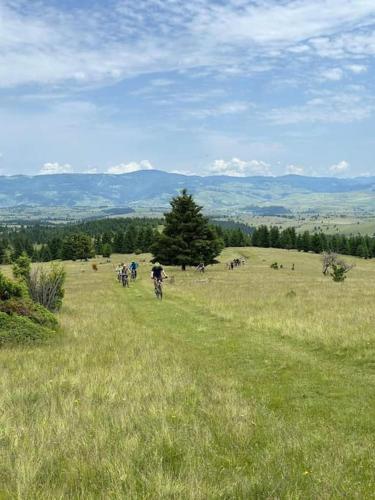 a group of people riding bikes in a grassy field at Starry Night Retreat in Subcetate