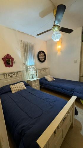 a bedroom with two beds and a ceiling fan at Casa Antigua in San Francisco