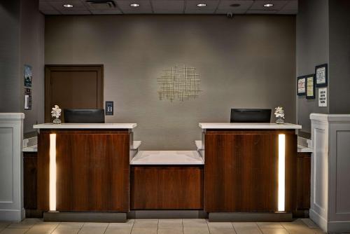 a reception desk with two laptops on top of it at Sonesta Atlanta Airport South in Atlanta
