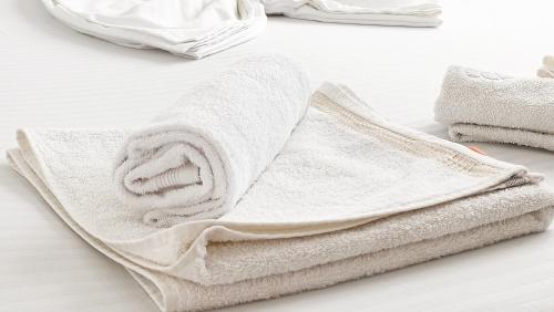 a white towel sitting on top of a table at Portofino Villa in Costinesti