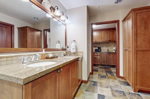 a bathroom with a sink and a large mirror at Resort at Squaw Creek's 128 in Olympic Valley