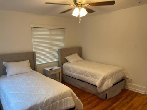 a bedroom with two beds and a ceiling fan at Charming Family Retreat in Augusta