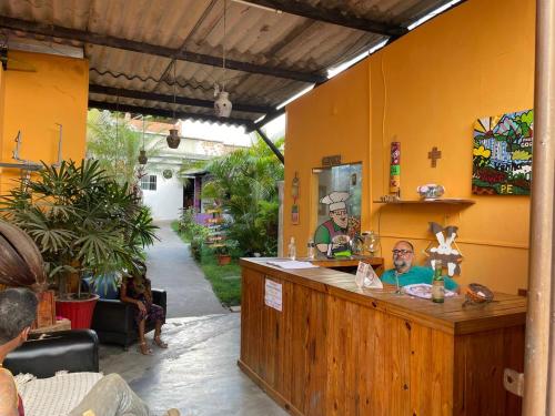 a man sitting at a counter in a restaurant at Pousada do Gord0 in Bonito