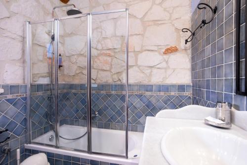 a bathroom with a shower and a sink at Aresti Mountain Resort in Agios Leon