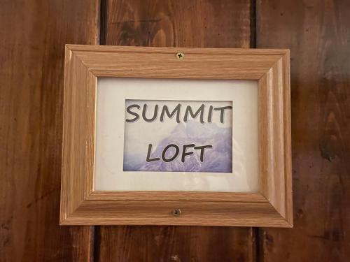 a picture in a wooden frame with the wordssummit lot at Fireside Inn & Hostel in Breckenridge