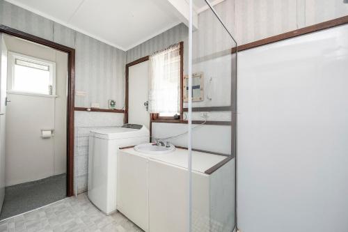 a white bathroom with a sink and a toilet at Blue View - UNINTERRUPTED OCEAN VIEWS FOR MILES in Guilderton