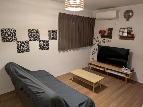 a living room with a couch and a tv at 9, Minamisuna 2, Entire house for rent, 南砂2 in Tokyo