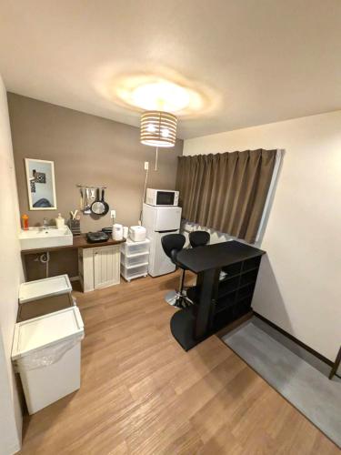 a living room with a desk and a kitchen at 9, Minamisuna 2, Entire house for rent, 南砂2 in Tokyo