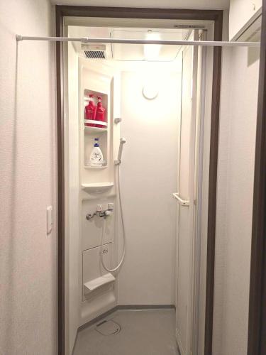 a shower in a bathroom with the door open at 9, Minamisuna 2, Entire house for rent, 南砂2 in Tokyo