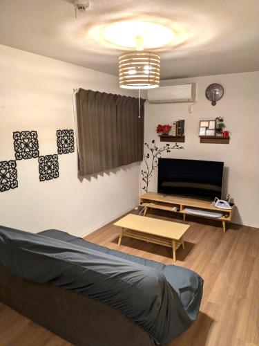 a living room with a couch and a tv at 9, Minamisuna 2, Entire house for rent, 南砂2 in Tokyo