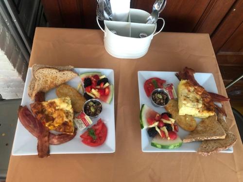 two plates of breakfast food on a table at La Belle Victorienne in Magog-Orford