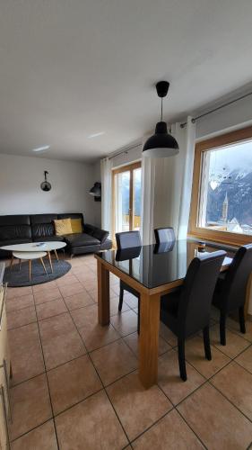 a living room with a table and chairs at Ferienwohnung Scandella Otto und Monika in Sent