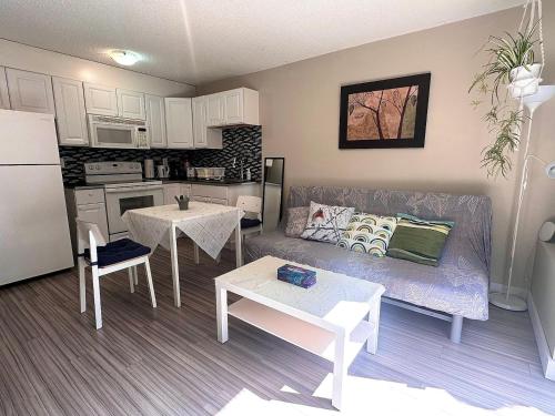 a living room with a couch and a kitchen at Capilano Happylife in North Vancouver