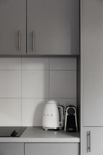 a white toaster sitting on a counter in a kitchen at MAC St Kilda Acland St by Melbourne Apartment Collection in Melbourne