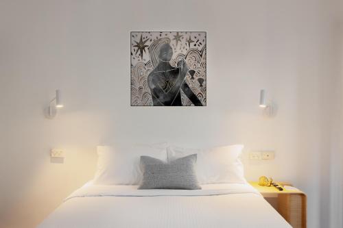 a bedroom with a bed and a picture on the wall at MAC St Kilda Acland St by Melbourne Apartment Collection in Melbourne