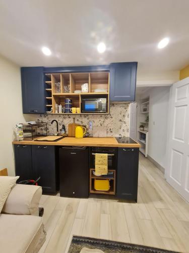 a kitchen with blue cabinets and a counter top at An Cuan - The Haven in Letterkenny