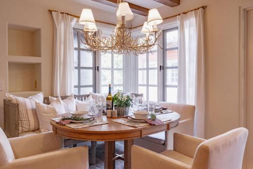 a dining room with a table and chairs and a chandelier at Idyllic Casita on Private Fairbanks Ranch Estate in Rancho Santa Fe