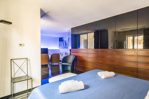 a room with a blue bed and chairs in it at Luxury suite 2 min dal Politeama - Free Parking in Palermo