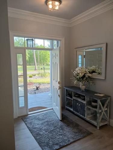 a room with a door and a mirror and a table at Horseshoe Manor in Little River