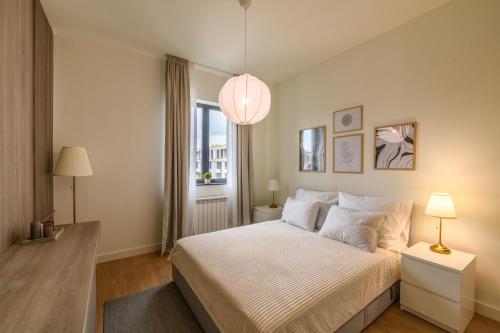 a bedroom with a large bed and a window at Belgrade Waterfront Residences - Beograd na vodi in Belgrade