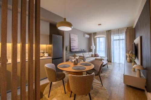 a living room with a table and chairs and a couch at Belgrade Waterfront Residences - Beograd na vodi in Belgrade