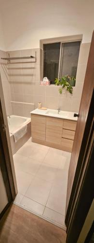 a bathroom with a tub and a sink and a window at Nest at Maggies in Melbourne
