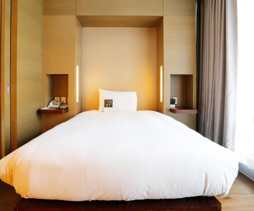 Postel nebo postele na pokoji v ubytování Grand Mercure Ambassador Changwon