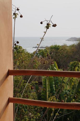 a view of the ocean from a balcony at Monte Uzulu Boutique Hotel in San Agustinillo