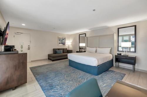 a large hotel room with a bed and a couch at Ocean View Hotel in Los Angeles