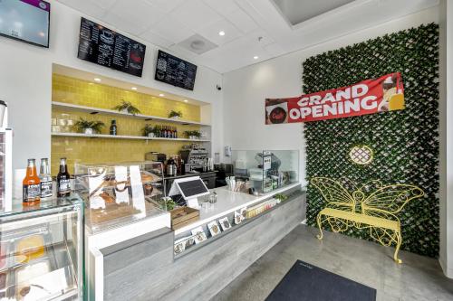 a store with a grand opening sign on the wall at Ocean View Hotel in Los Angeles