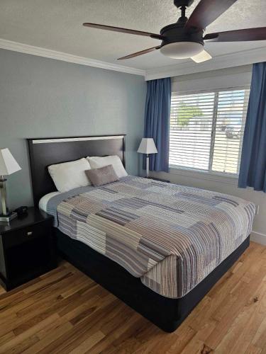a bedroom with a bed and a ceiling fan at El Rancho Motel in Williams