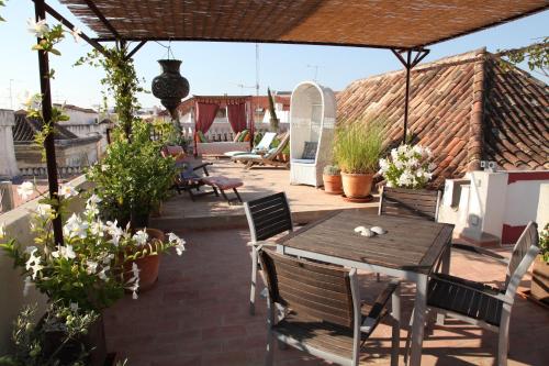 a patio area with tables, chairs and umbrellas at Casa Beleza do Sul in Tavira
