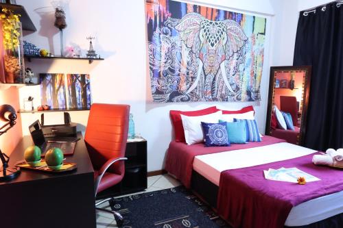 Giường trong phòng chung tại Recreio - CorAll Experience - 2 Quartos e 1 Suíte