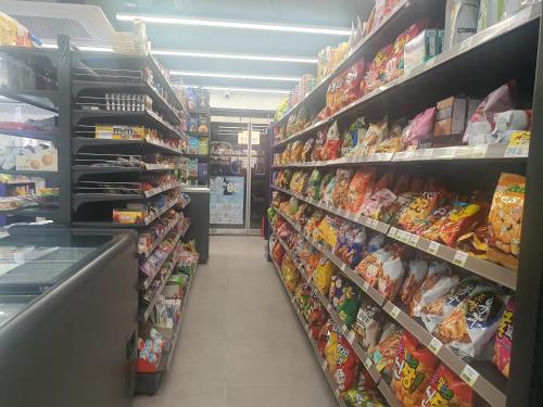 a store aisle of a grocery store filled with food at Bluebird Hotel in Incheon