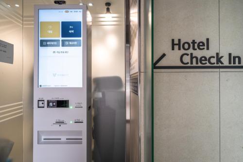 a hotel check in machine next to a sign at Bluebird Hotel in Incheon