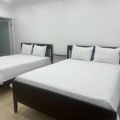 two beds sitting next to each other in a room at Sweet Sunset 4 Playa Rompeolas, Aguadilla in Aguadilla