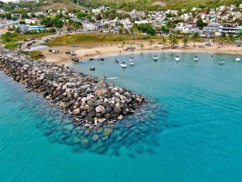 an aerial view of a beach with boats in the water at Sweet Sunset 4 Playa Rompeolas, Aguadilla in Aguadilla