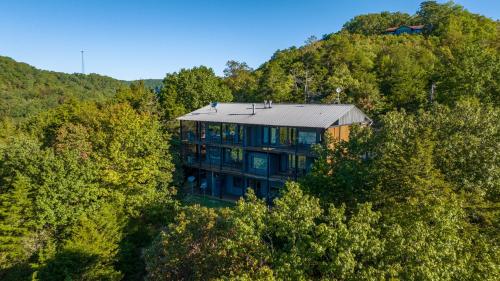 an aerial view of a house in the trees at Beaver Lakefront Cabins - Couples Only Getaways in Eureka Springs