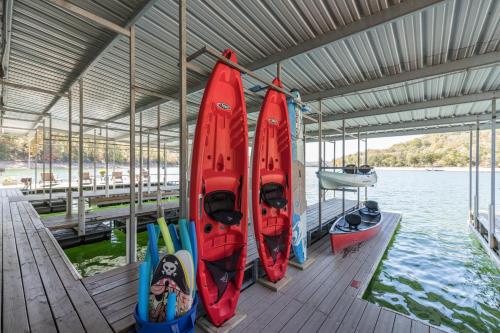 a group of kayaks on a dock next to the water at Beaver Lakefront Cabins - Couples Only Getaways in Eureka Springs