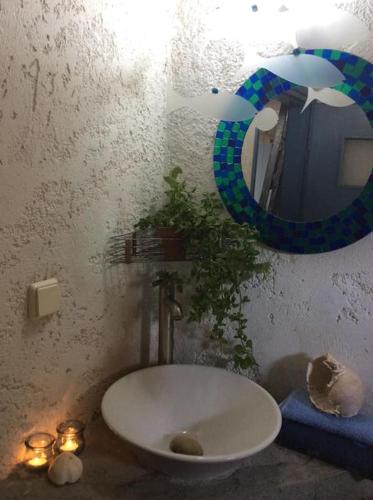 a bathroom with a white sink and a mirror at Summer Stoned Maisonette in Kondiás