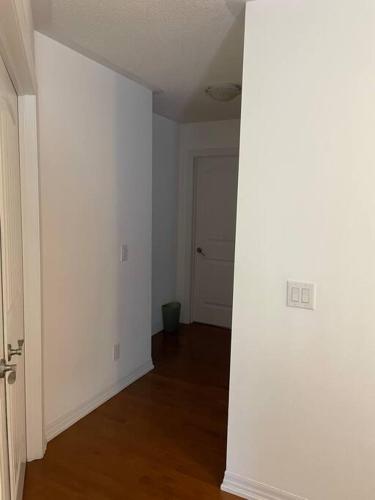 an empty room with a white wall and a door at Executive End Unit Townhome in Milton