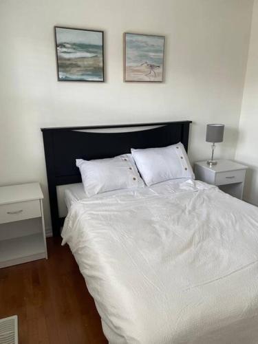 a bedroom with a large white bed with two night stands at Executive End Unit Townhome in Milton