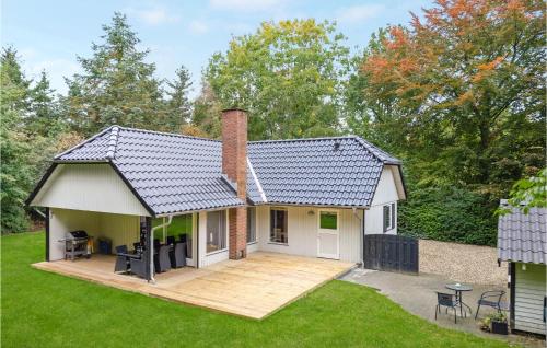 a house with a deck in the yard at 4 Bedroom Nice Home In Toftlund in Toftlund